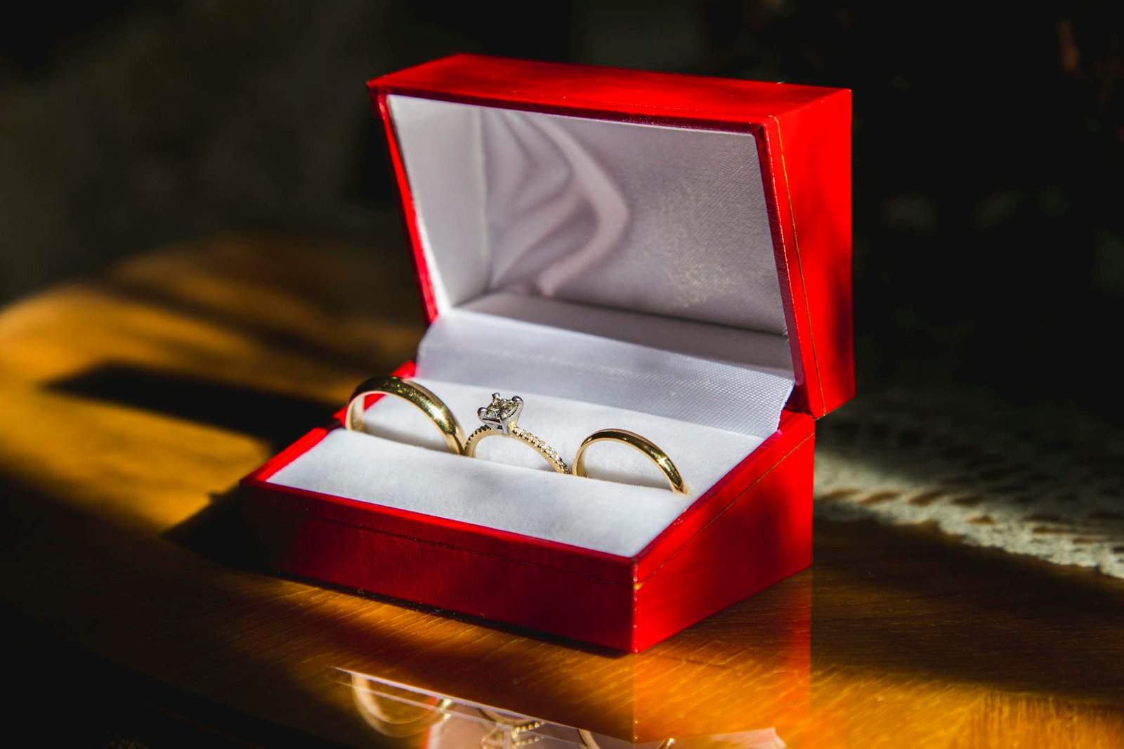 Close-up of luxury gold wedding rings in an elegant red box, perfect symbol of romance and commitment.