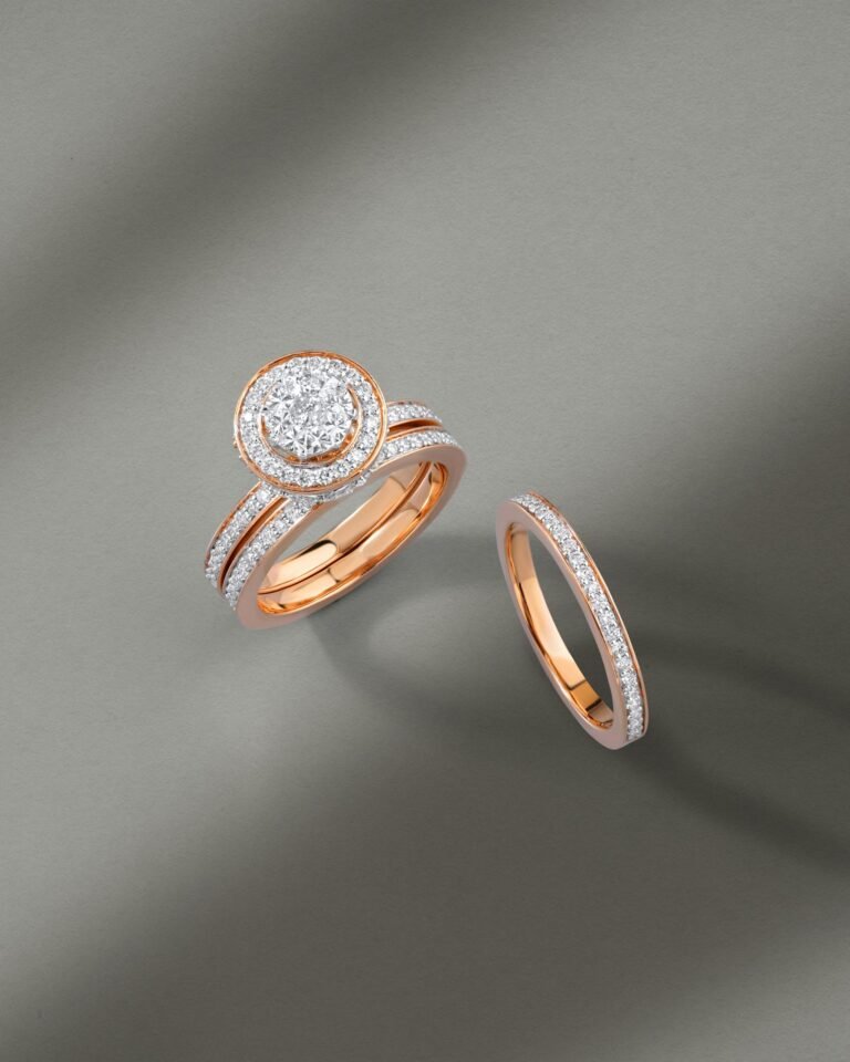 Exquisite diamond rings with rose gold bands displayed on a minimalist grey surface, showcasing intricate design.